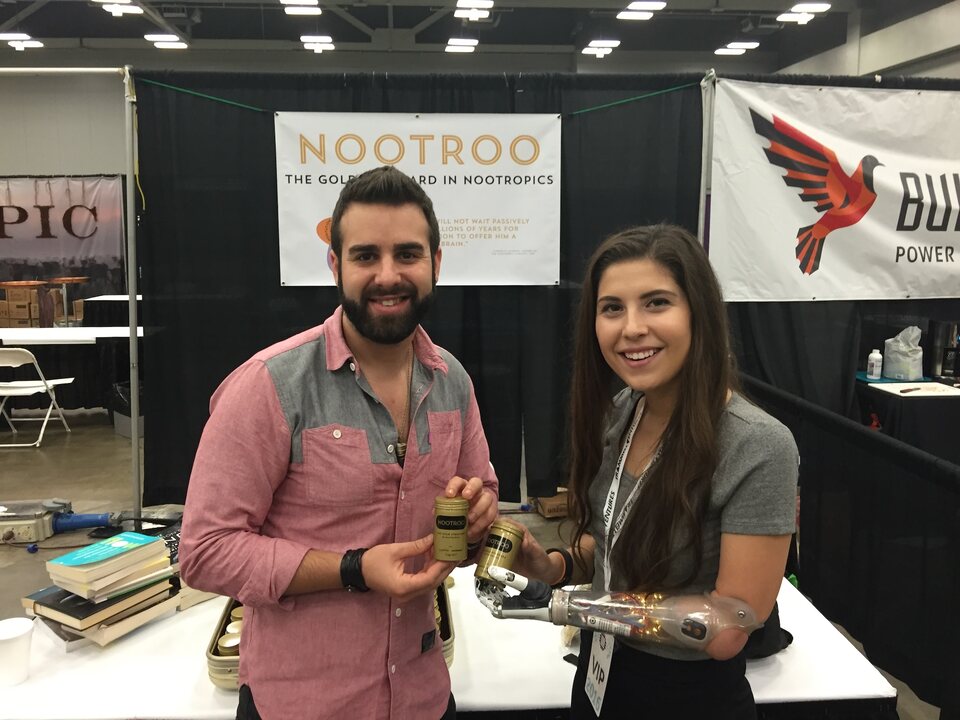 Eric Matzner demonstrating Nootroo beside a prosthetic hand